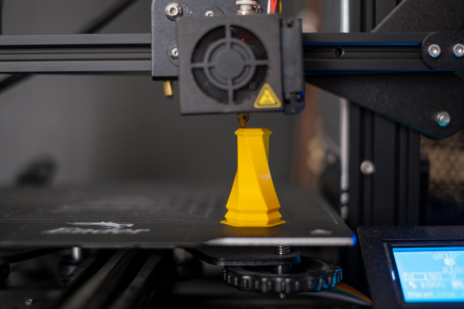 a 3d printer with a yellow cone on top of it